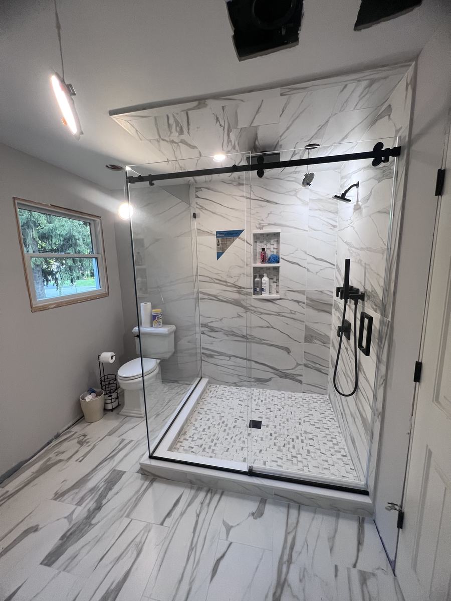 Frameless single sliding shower door with matte black hardware